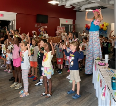 Children worshipping at The Faith Center