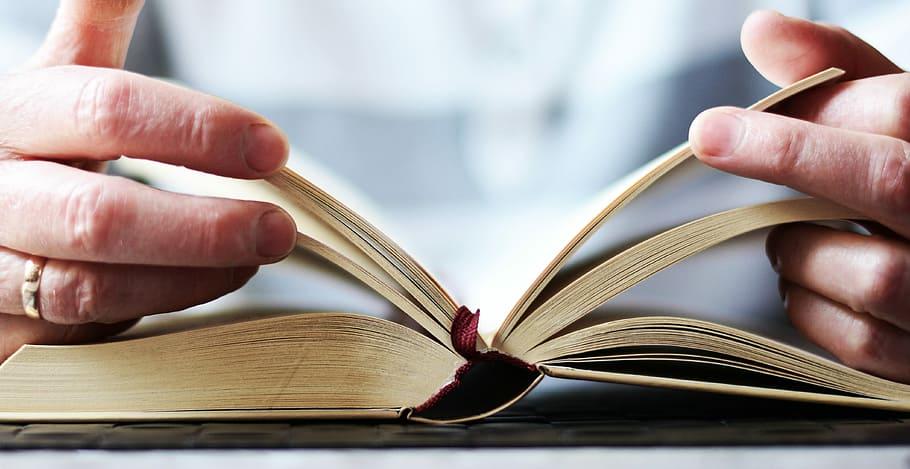 Hands holding an open Bible